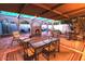 Inviting outdoor patio with ample seating, a decorative fireplace, and a covered area for entertaining at 7736 E Hazelwood St, Scottsdale, AZ 85251
