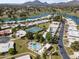 An aerial view shows the community, including a swimming pool, tennis courts, and lake at 7856 E Via Marina --, Scottsdale, AZ 85258