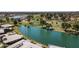 Aerial view showcases golf course with pond and residential area featuring palm trees at 7856 E Via Marina --, Scottsdale, AZ 85258