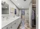 Bathroom showcasing double sinks, updated fixtures, a walk-in closet and stylish tile flooring at 7856 E Via Marina --, Scottsdale, AZ 85258