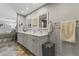 Bright bathroom featuring a double vanity, modern mirrors, and access to the bedroom at 7856 E Via Marina --, Scottsdale, AZ 85258