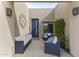 Covered front patio seating with comfortable seating and plants at 7856 E Via Marina --, Scottsdale, AZ 85258