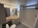 Bathroom features a tiled vanity, sink, decorative mirror, and walk in shower at 8103 E Southern Ave # 157, Mesa, AZ 85209