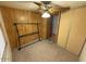 Bedroom features ceiling fan and wood paneled walls at 8103 E Southern Ave # 157, Mesa, AZ 85209