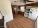 Well-lit kitchen features tile backsplash, hardwood floors, and modern appliances at 8103 E Southern Ave # 157, Mesa, AZ 85209