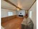 Cozy living room with wood laminate flooring, ceiling fan, and decorative fireplace at 8103 E Southern Ave # 157, Mesa, AZ 85209