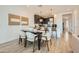 Cozy dining area features a modern table set with seating for six, open to the kitchen at 8149 E Petunia Ave # 1057, Mesa, AZ 85212
