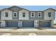New townhomes feature attached garages and modern two-tone paint scheme at 8149 E Petunia Ave # 1057, Mesa, AZ 85212