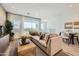 Comfortable living room featuring a plush sectional, stylish coffee table, and serene outdoor views at 8149 E Petunia Ave # 1057, Mesa, AZ 85212
