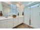 Bright bathroom featuring double sinks, modern fixtures, and a glass-enclosed shower at 8331 E Petunia Ave, Mesa, AZ 85212
