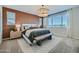 Inviting bedroom with a patterned accent wall, stylish lighting, and a comfortable bed at 8331 E Petunia Ave, Mesa, AZ 85212