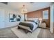 Inviting bedroom with a patterned accent wall, stylish lighting, and a comfortable bed at 8331 E Petunia Ave, Mesa, AZ 85212