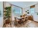 Inviting dining area with a wood table, natural light, and a decorative plant adding warmth to the space at 8331 E Petunia Ave, Mesa, AZ 85212