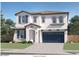 Charming two-story home with a Spanish-style elevation, blue shutters, and a two-car garage at 8331 E Petunia Ave, Mesa, AZ 85212