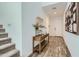 Inviting foyer featuring wood-look flooring, a console table with decor, and a staircase at 8331 E Petunia Ave, Mesa, AZ 85212