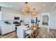 Bright kitchen with white cabinets, quartz countertops, an island with pendant lighting, and stainless steel appliances at 8331 E Petunia Ave, Mesa, AZ 85212