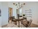 Bright home office featuring a wood desk, contemporary lighting, and decorative golf clubs on floating shelves at 8331 E Petunia Ave, Mesa, AZ 85212