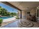 Outdoor living space with covered patio, stone accents, and views of the pool and backyard at 8441 W Foothill Dr, Peoria, AZ 85383
