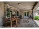Back patio featuring stone flooring, decorative mosaic, and ample seating area at 8441 W Foothill Dr, Peoria, AZ 85383