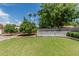 Spacious backyard featuring a well-manicured lawn, mature trees, and a charming white picket fence at 8441 W Foothill Dr, Peoria, AZ 85383