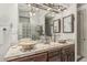 Bathroom featuring tiled double sinks and a shower encased in glass at 8441 W Foothill Dr, Peoria, AZ 85383