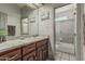 Bathroom featuring wood cabinetry, granite countertop and tile flooring with view to separate shower/tub room at 8441 W Foothill Dr, Peoria, AZ 85383