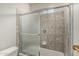 Bathtub with tile surround and sliding glass shower door at 8441 W Foothill Dr, Peoria, AZ 85383