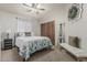 Bedroom with botanical bedding, a ceiling fan, and dark wooden closet doors at 8441 W Foothill Dr, Peoria, AZ 85383