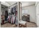 Walk-in closet featuring two sections, with a seating bench on the right at 8441 W Foothill Dr, Peoria, AZ 85383