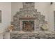Close-up of a custom stone fireplace with unique decorative elements and a cozy ambiance at 8441 W Foothill Dr, Peoria, AZ 85383