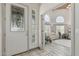 Bright foyer leading to a spacious living area with vaulted ceilings, large windows, and stylish decor at 8441 W Foothill Dr, Peoria, AZ 85383