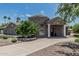 Stunning stone home with lush landscaping, unique architectural details, and a welcoming circular driveway at 8441 W Foothill Dr, Peoria, AZ 85383