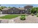 Charming stone home with a well-manicured front yard featuring decorative rock, shrubs, and stone path at 8441 W Foothill Dr, Peoria, AZ 85383