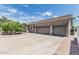 Spacious three-car garage with a long driveway, lovely brick trim, and mature landscaping at 8441 W Foothill Dr, Peoria, AZ 85383