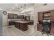 Gourmet kitchen with a large island, custom cabinetry, and stainless steel appliances adjacent to the dining area at 8441 W Foothill Dr, Peoria, AZ 85383