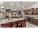 Updated kitchen with stainless steel appliances, granite countertops, and a center island with seating at 8441 W Foothill Dr, Peoria, AZ 85383