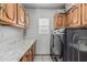 Laundry room featuring cabinets, counter, and appliances at 8441 W Foothill Dr, Peoria, AZ 85383