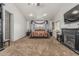 The primary bedroom features a four-poster bed, carpeting, and a cozy fireplace at 8441 W Foothill Dr, Peoria, AZ 85383
