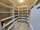 Walk-in pantry with white shelving providing ample storage space for food and kitchen essentials at 8441 W Foothill Dr, Peoria, AZ 85383