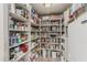 Fully stocked walk-in pantry with white shelving providing ample storage space for food and kitchen essentials at 8441 W Foothill Dr, Peoria, AZ 85383