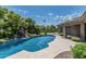 Landscaped backyard with a sparkling pool, rock waterfall feature, and ample space for outdoor enjoyment at 8441 W Foothill Dr, Peoria, AZ 85383