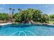 Beautiful pool featuring a rock waterfall and lush tropical landscaping, perfect for relaxation and entertainment at 8441 W Foothill Dr, Peoria, AZ 85383