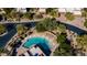 Aerial view of circular community pool with lounge chairs and mature trees at 8502 E Cave Creek Rd # 61, Carefree, AZ 85377