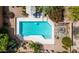 Aerial view of a sparkling pool, lounge chairs, and a fire pit surrounded by lush landscaping at 8502 E Cave Creek Rd # 61, Carefree, AZ 85377