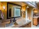 Bathroom features stone countertop, cabinets, modern fixtures, and unique glass block window detail at 8502 E Cave Creek Rd # 61, Carefree, AZ 85377