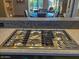 A close-up of the modern stainless steel cooktop with multiple burners, set in a stylish kitchen with stone countertops at 8502 E Cave Creek Rd # 61, Carefree, AZ 85377