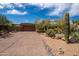 Exterior view of a brown home with drought resistant landscaping and a long driveway at 8502 E Cave Creek Rd # 61, Carefree, AZ 85377