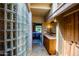 Bright hallway featuring glass block wall design leads to Primary suite bathroom and bedroom at 8502 E Cave Creek Rd # 61, Carefree, AZ 85377