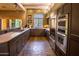 Modern kitchen featuring granite countertops, stainless steel appliances, and rustic wood beam ceiling at 8502 E Cave Creek Rd # 61, Carefree, AZ 85377