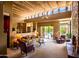 Bright living room featuring beamed ceilings, clerestory windows, a fireplace and sliding glass doors to the pool at 8502 E Cave Creek Rd # 61, Carefree, AZ 85377
